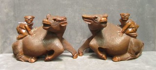 A pair of Eastern carved hardwood figures of seated buffalo 6"