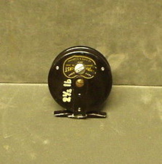 A pierced metal fishing reel