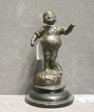 A 19th Century bronze figure of a child crying, raised on a turned wooden base, indistinctly signed, 7"