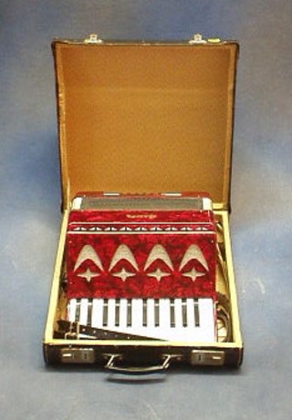 A Galiha accordion with 12 buttons and 15 keys, contained in a fibre carrying case