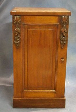A pair of Victorian mahogany pedestal cupboard enclosed by panelled doors, raised on platform bases 19"