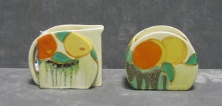 A Clarice Cliff pottery cream jug and sugar bowl of circular form decorated oranges, the base marked RD 764549