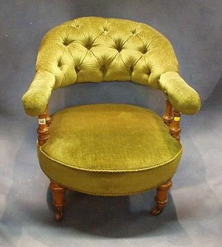 A Victorian oak framed tub back chair with bobbin turned decoration, upholstered green buttoned material, on turned supports