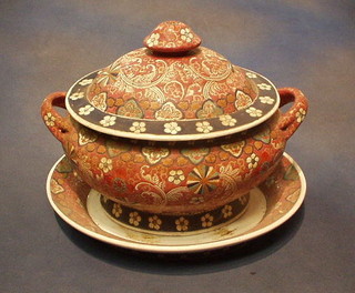 An Oriental style twin handled tureen and cover with matching stand decorated in polychrome enamels