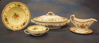 A 74 piece Spode Rockingham pattern dinner service comprising 2 oval twin handled tureens and 1 cover, 8 twin handled soup bowls (7 cracked), 13 circular soup saucers (7 cracked) 6 soup bowls, sauce boat and stand, 13 tea plates (3 cracked), 14 side plates (4 cracked), 16 dinner plates (9 cracked)