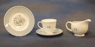 An 18 piece Susie Cooper coffee service with blue banding and floral decoration comprising bread plate, 6 tea plates, cream jug, 5 cups and saucers