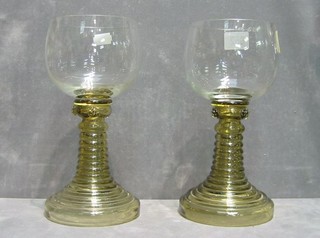 A pair of half litre goblets raised on green glass stems