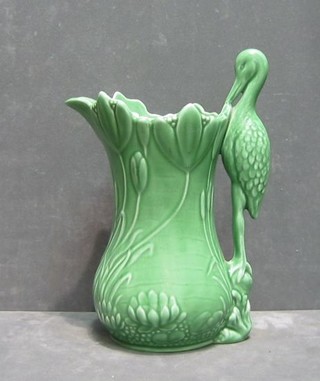 A Sylvac green glazed jug the handle in the form of a stork, the base marked 1960 Sylvac 111 9"