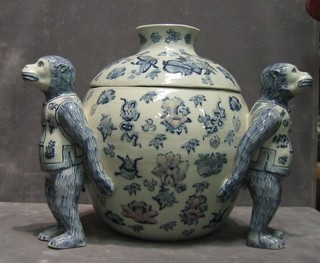 An Oriental 3 handled blue and white porcelain urn and cover supported by Monkeys 11" (f)