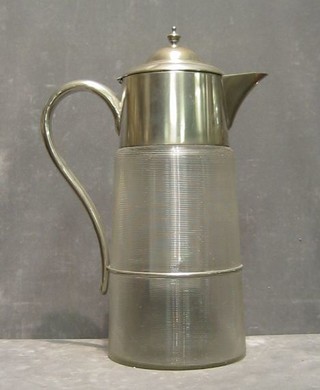 A large glass lemonade jug with silver plated top