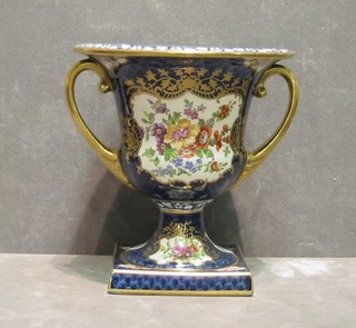 A 19th/20th Century pottery twin handled urn with blue and gilt banding and panels decorated birds amidst flowering branches 6" and a pair of Worcester style twin handled vases 10" (1f)