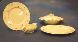 A 7 piece Clarice Cliff pottery dinner service with oval meat plate, 2 tureens and covers, 3 dinner plates and a side plate, the base marked RD no. 840076 together with a matching sauce boat