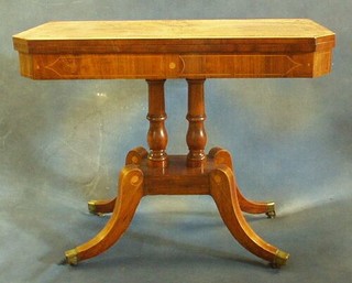 A Georgian mahogany lozenge shaped inlaid mahogany card table, raised on 2 columns with square base, on splayed feet ending in brass caps and castors 36"