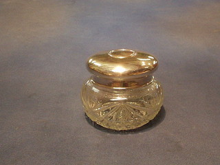 A cut glass dressing table jar with silver coloured lid