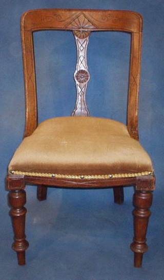 A pair of Victorian carved oak bar back dining chairs with carved splat and upholstered seat on turned supports