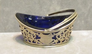 An Edwardian pierced silver boat shaped dish with blue glass liner, Birmingham 1911