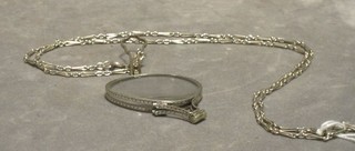 A pair of lady's cut steel lorgnettes hung on a silver coloured chain