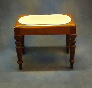 A 19th Century mahogany bidet complete with china liner raised on turned supports 21"