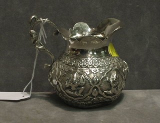 An Eastern embossed silver cream jug