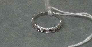 A lady's white gold half eternity ring set 6 rubies and 6 diamonds