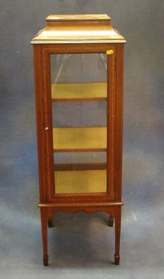 An Edwardian inlaid mahogany display cabinet enclosed by glazed panelled doors, raised on square tapering supports ending in spade feet 15"