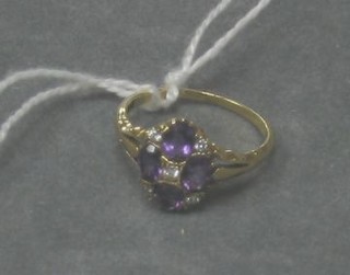 A lady's gold dress ring set 4 oval cut amethysts surrounded by diamonds
