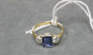 A lady's 18ct gold dress ring set a rectangular cut sapphire supported by 2 diamonds
