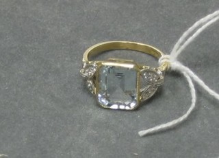 A lady's gold dress ring set a rectangular cut aquamarine and 10 diamonds to the shoulders