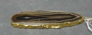 An agate pendant contained in a "gold" mount and a tie clip