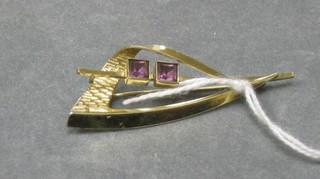 A gilt metal brooch set amethysts