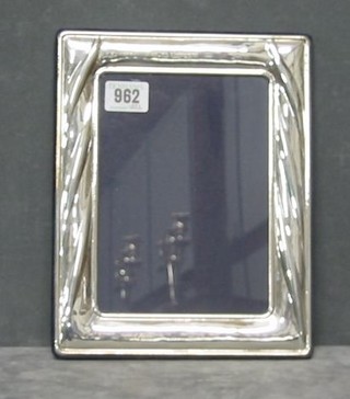 A modern plain silver photograph frame 10" x 7"