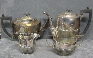 A 4 piece silver plated tea service with demi-reeded decoration with teapot, coffee pot, twin handled sugar bowl and cream jug