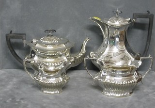 An oval silver plated tea service with demi-reeded decoration comprising teapot, twin handled sugar bowl and cream jug and a hotwater jug