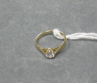 A lady's gold solitaire diamond engagement ring