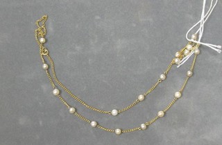 A gold chain interspaced seed pearls