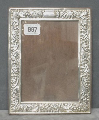 A modern embossed silver easel photograph frame 9" x 7"