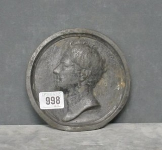 A circular metal plaque depicting George III