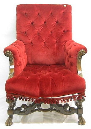 A Continental carved mahogany show frame chair upholstered in red material with shaped stretcher and on French cabriole supports