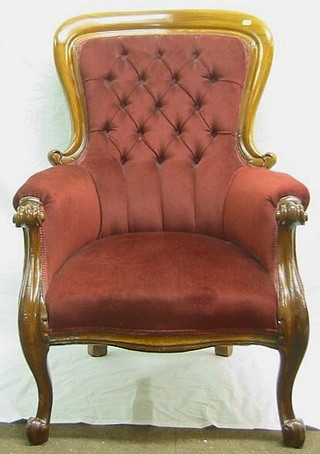 A Victorian mahogany showframe armchair upholstered in red buttoned material on French cabriole supports