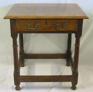 An 18th Century oak side table fitted a frieze drawer, raised on turned and block supports 25"