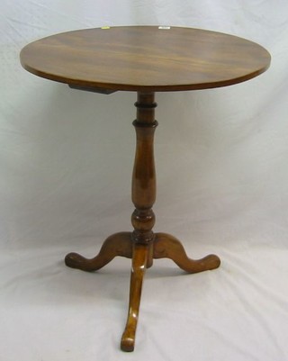 A 19th century circular mahogany wine table raised on pillar and tripod supports 24"