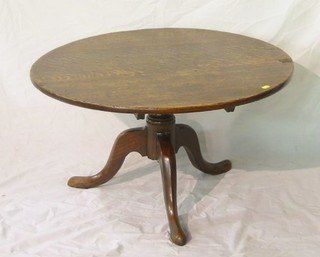 An 18th/19th Century circular oak tea table, raised on turned column supports (somewhat reduced in height)