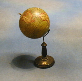 A miniature German Terrestrial Globe marked ERD-GLOBUS 10 Cent Nd neusten Quellen Entw BERLIN Ludw Jul Heymann, raised on an ebonised stand