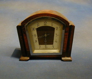 An Art Deco 8 day mantel clock with arched dial contained in an oak case by Enfield