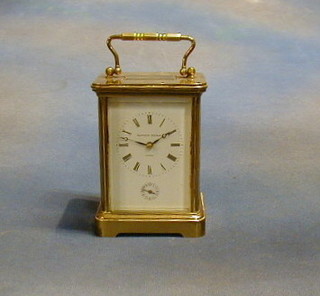 A 19th Century French  8 day striking alarm carriage clock with 11 jewels, with porcelain dial and Roman numerals by Mathew Norman of London