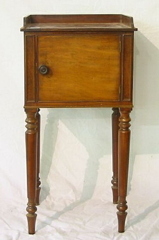 A Georgian mahogany pot cupboard with three-quarter gallery and cupboard enclosed by panelled doors, raised on turned supports 62"