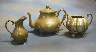A pewter teapot and a collection of pewter sugar bowls, cream jugs etc,