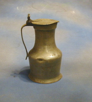 A pewter jug with hinged lid and acorn thumb piece 9 1/2"
