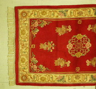 A modern red ground and floral patterned Chinese rug 72" x 46" 60-90