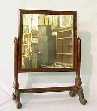 A William IV rectangular plate dressing table mirror contained in a mahogany swing frame